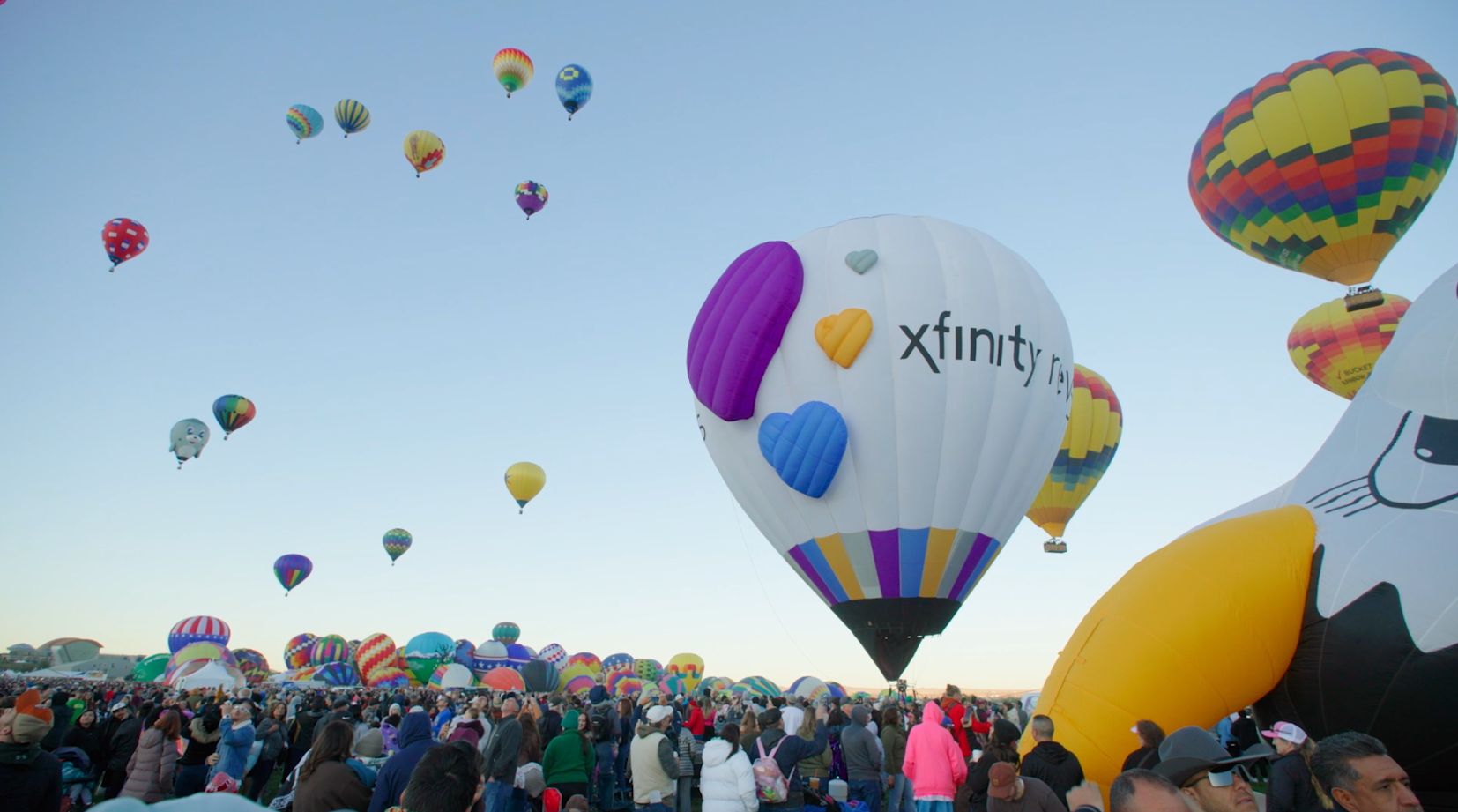 Hot air balloons flying at the 2025 Albuquerque International Balloon Fiesta